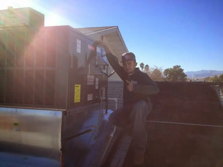 HVAC technician performing Boiler Repair on a rooftop unit in Martha Lake